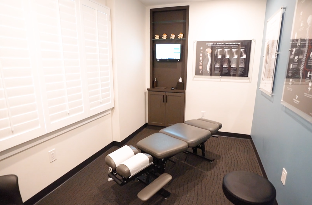 Modern chiropractic treatment room with adjusting table